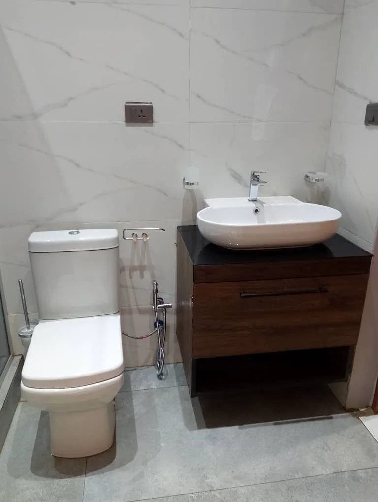 Basin, wooden vanity and bathroom fixtures